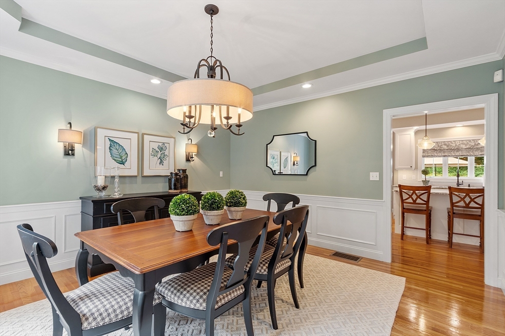 3 Coderre Way Andover, MA 01810 - Photo 6 of 42 a view of a dining room with furniture a chandelier and wooden floor