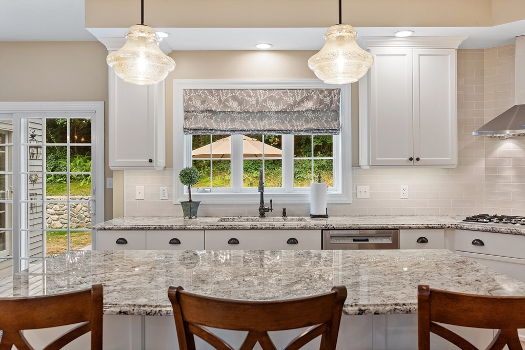 3 Coderre Way Andover, MA 01810 - Photo 9 of 42 a kitchen with granite countertop a stove a sink and a dining table