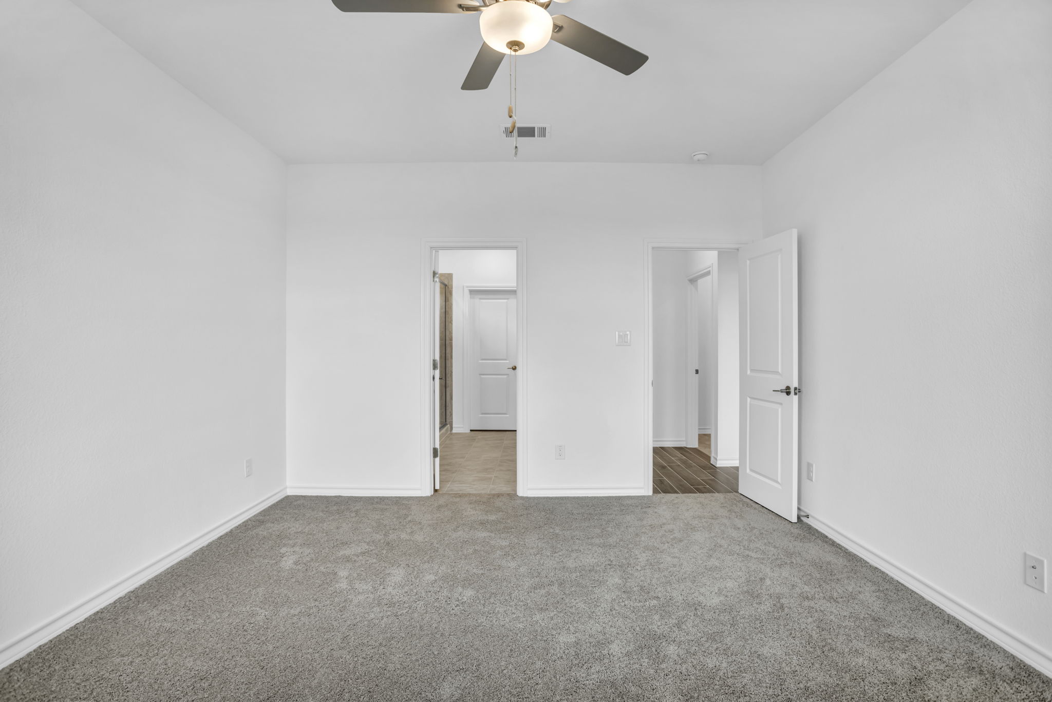 131 Adeline Road Hutto, TX 78634 - Photo 22 of 30 A spacious, naturally illuminated room featuring plush carpeting and a modern ceiling fan for ultimate comfort.