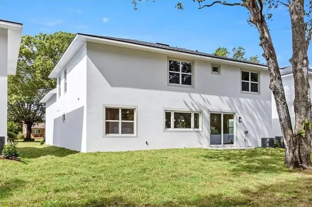 a view of an house with backyard space and garden