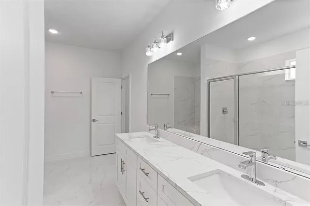 a bathroom with a double vanity sink and a mirror