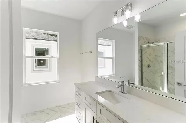 a bathroom with a sink a vanity and a mirror