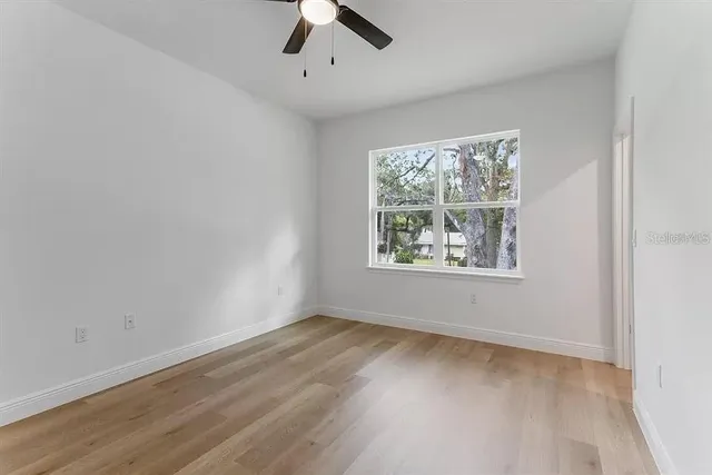 wooden floor in an empty room with a window
