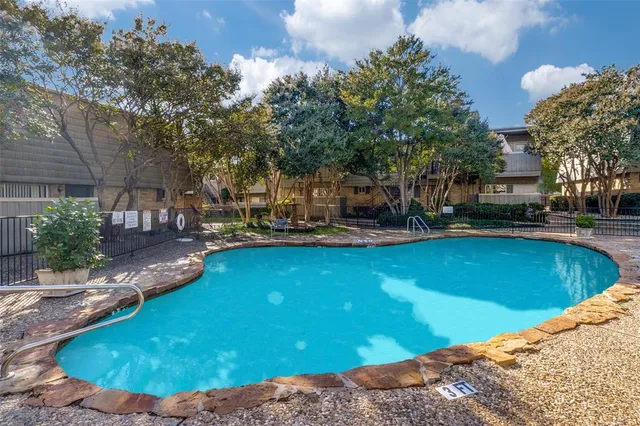 a view of a swimming pool with outdoor seating