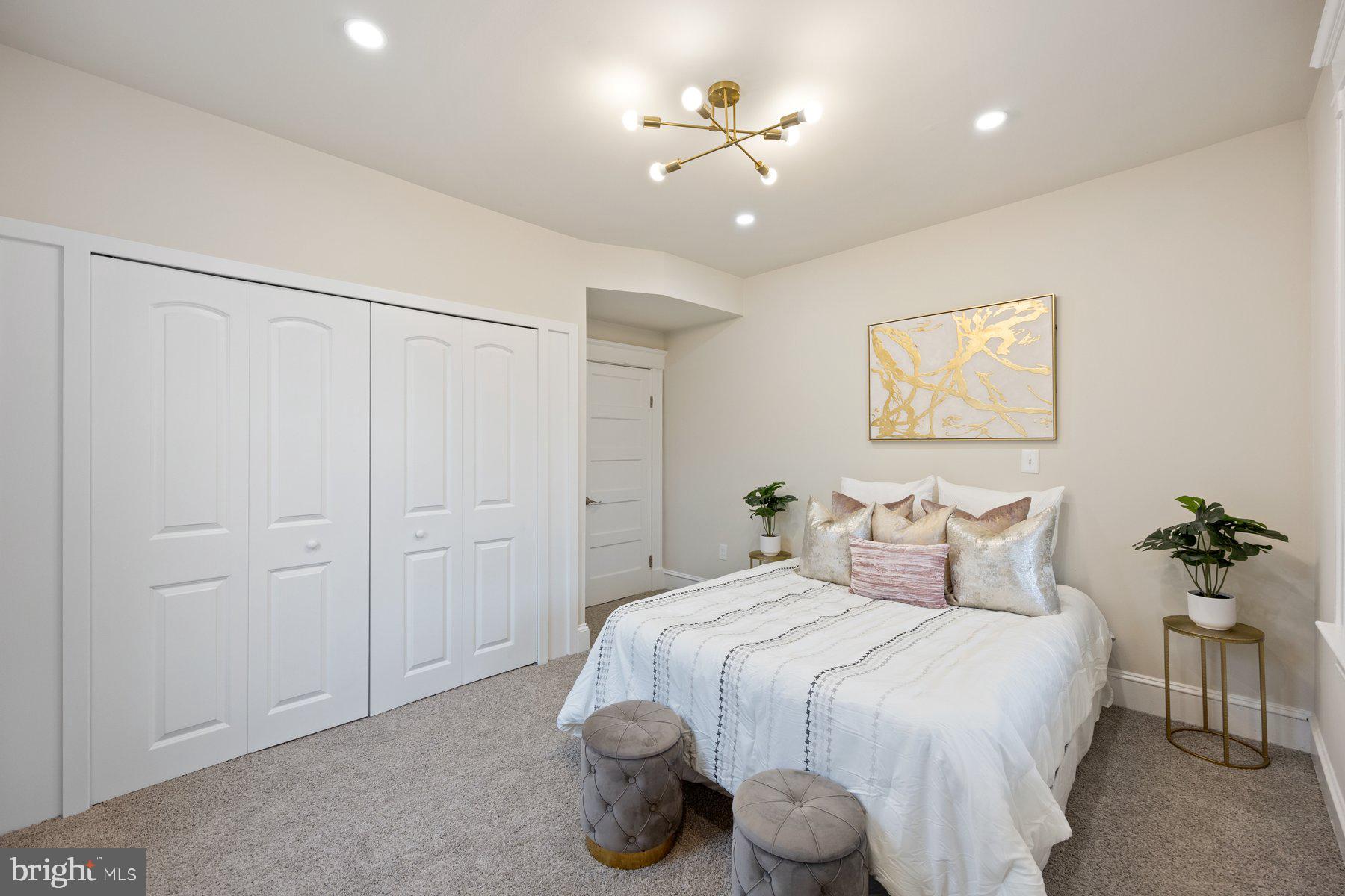 5512 Tramore Road Baltimore, MD 21214 - Photo 16 of 37 a bedroom with a bed and a chandelier