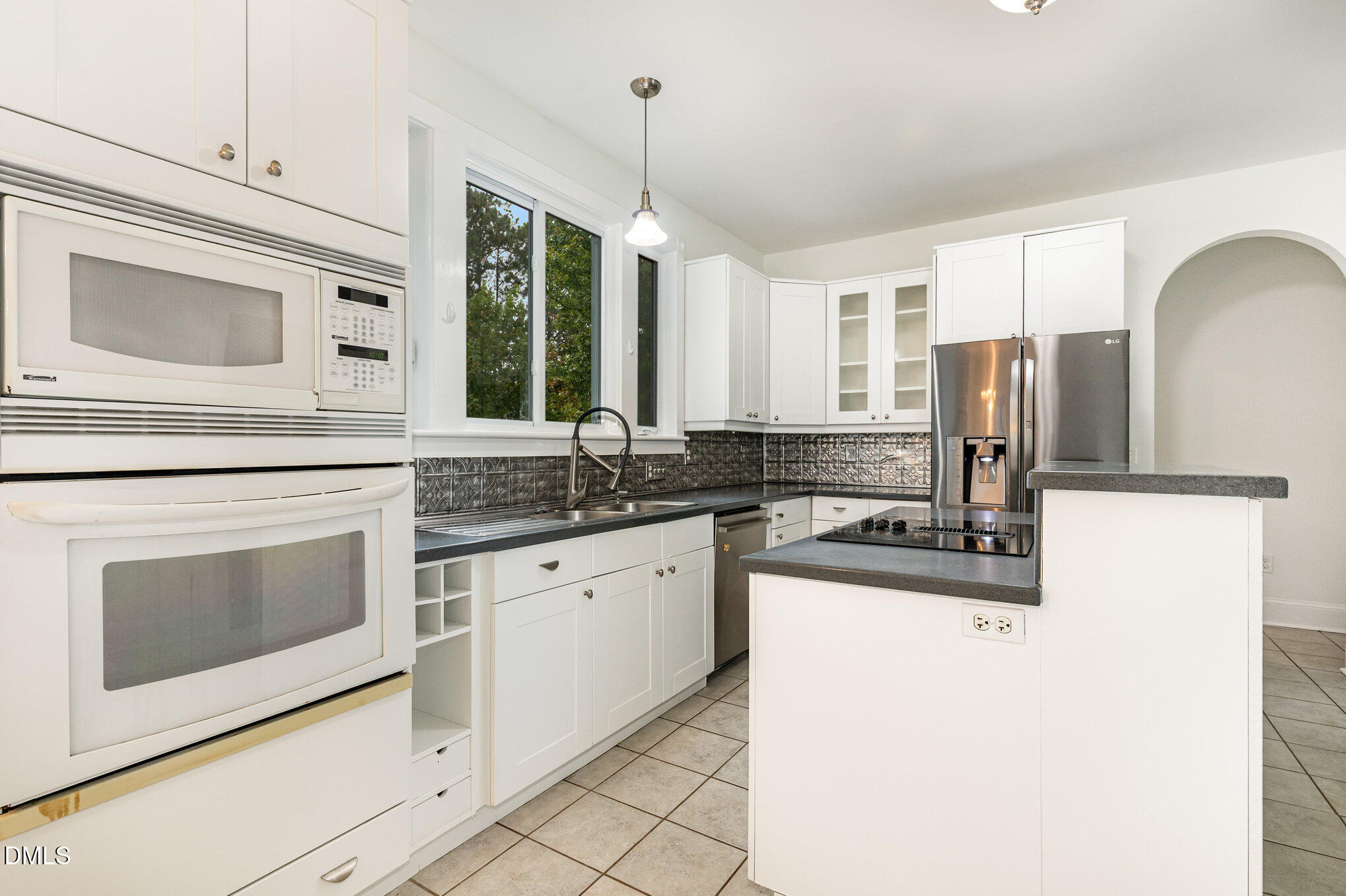 9261 Blackley Lake Road Wake Forest, NC 27587 - Photo 15 of 41 a kitchen with stainless steel appliances granite countertop a stove a sink and a microwave