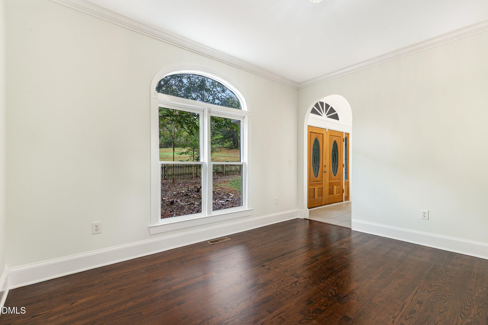 9261 Blackley Lake Road Wake Forest, NC 27587 - Photo 19 of 41 an empty room with wooden floor exposed radiator and windows