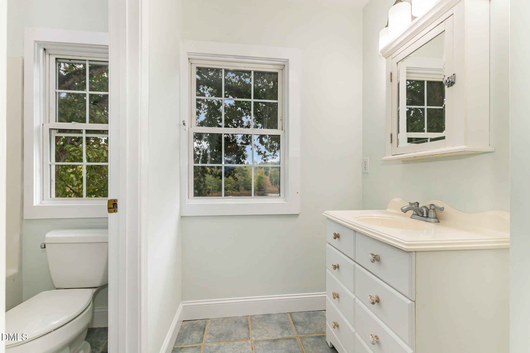 9261 Blackley Lake Road Wake Forest, NC 27587 - Photo 26 of 41 a bathroom with a sink toilet and window