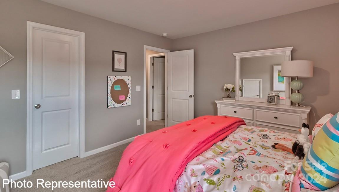 82 Dandelion Road Fletcher, NC 28732 - Photo 28 of 29 a bedroom with a bed and a lamp on dresser