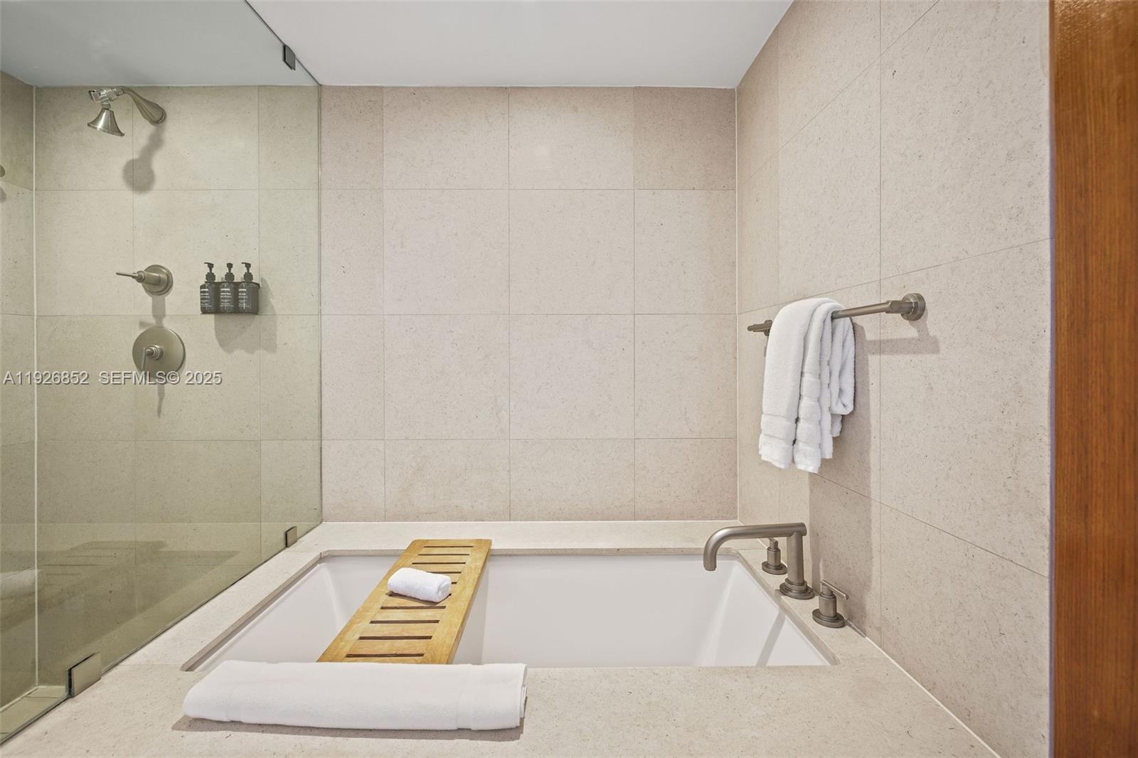 6801 Collins Avenue, Unit 614 Miami Beach, FL 33141 - Photo 12 of 49 a bathroom with a bath tub