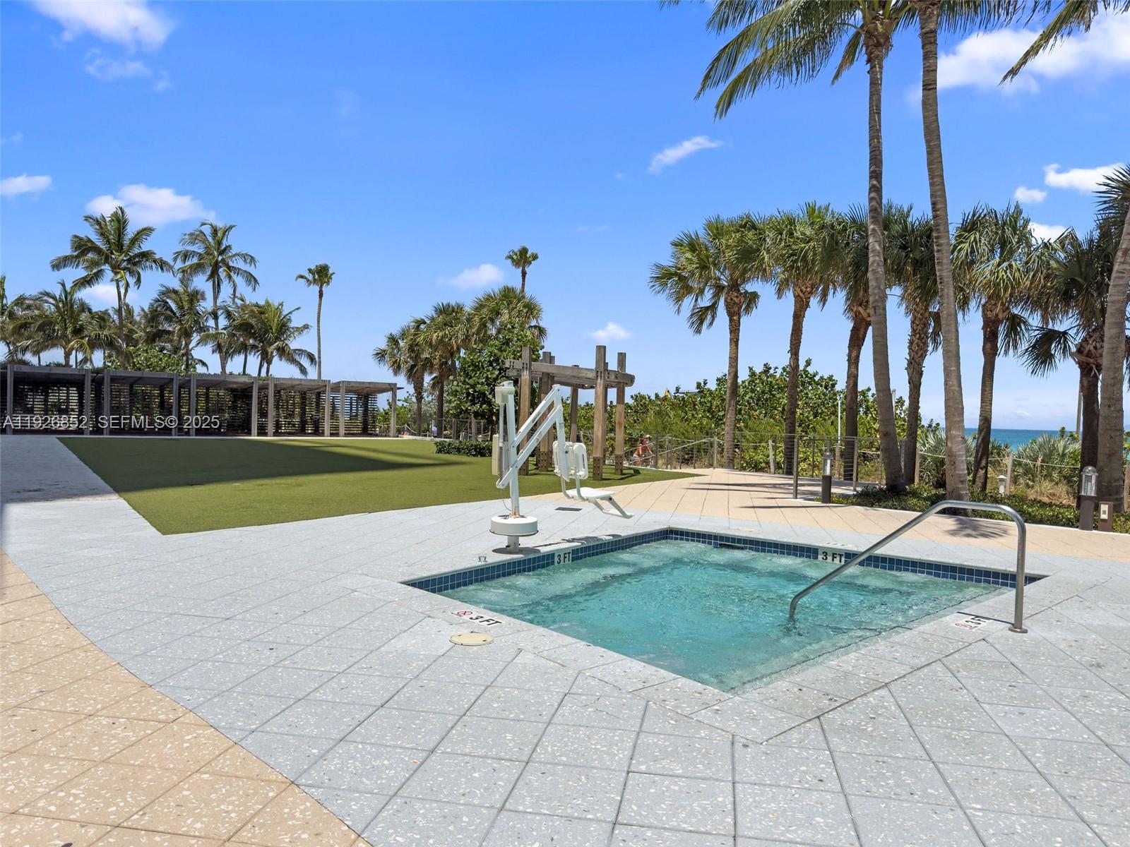 6801 Collins Avenue, Unit 614 Miami Beach, FL 33141 - Photo 21 of 49 a view of a swimming pool with a lounge chair