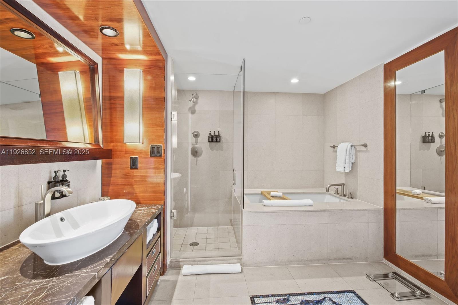 6801 Collins Avenue, Unit 614 Miami Beach, FL 33141 - Photo 10 of 49 a bathroom with a sink a toilet a shower and a mirror