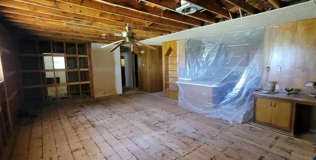 a kitchen with stainless steel appliances a sink cabinets and wooden floor