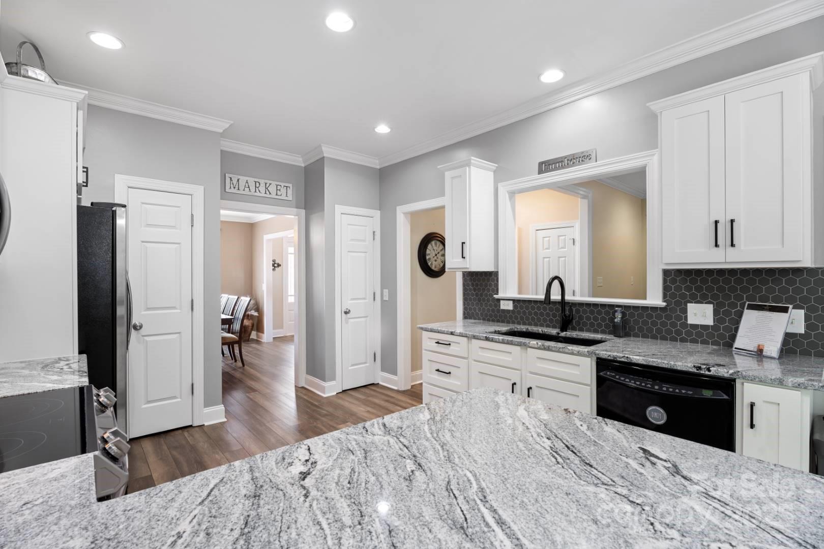 153 Canyon Road Mocksville, NC 27028 - Photo 14 of 46 a large kitchen with stainless steel appliances granite countertop a refrigerator and a stove top oven
