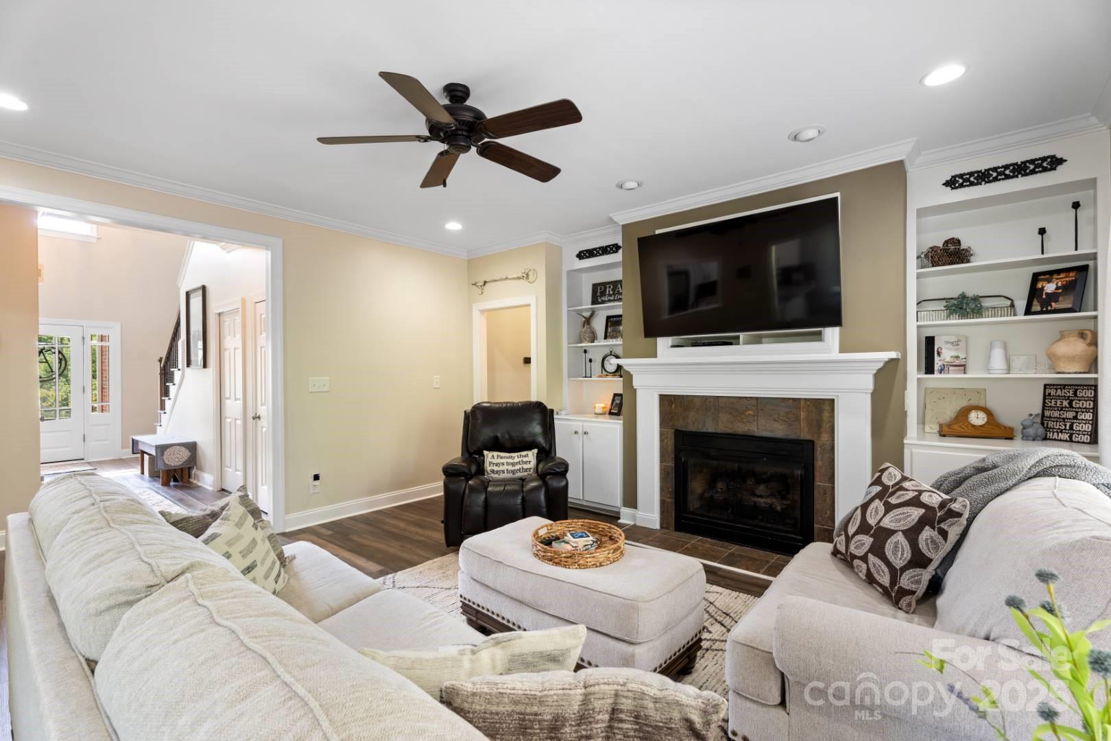 153 Canyon Road Mocksville, NC 27028 - Photo 21 of 46 a living room with furniture a flat screen tv and a fireplace