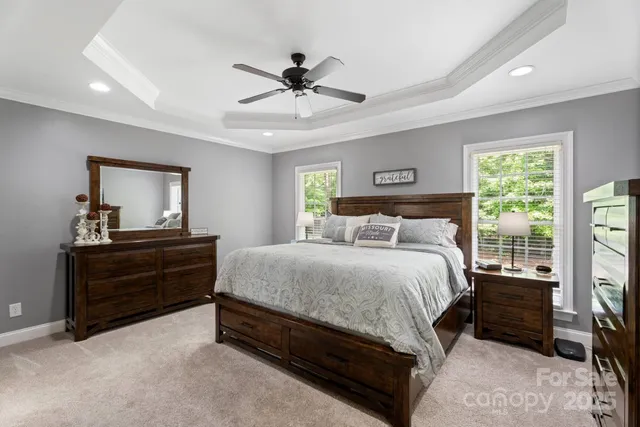 a bedroom with a large bed and a chandelier