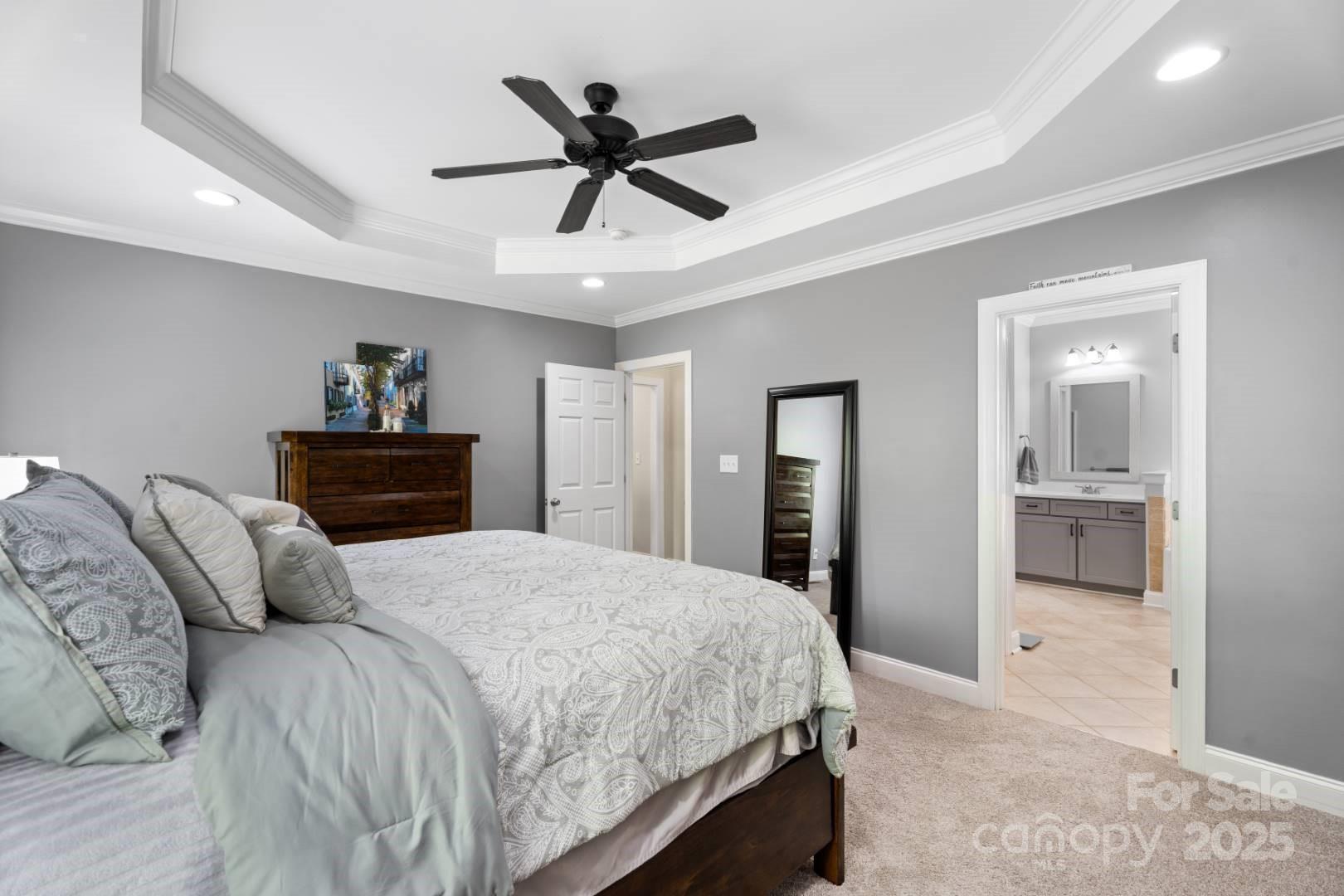 153 Canyon Road Mocksville, NC 27028 - Photo 25 of 46 a bedroom with a large bed and a chandelier