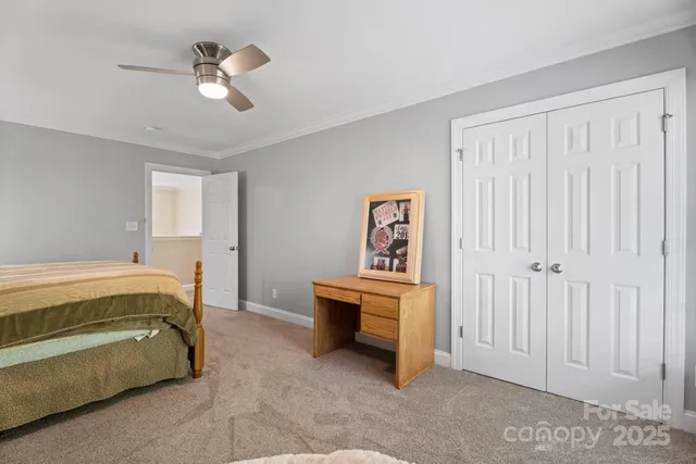 a spacious bathroom with a granite countertop sink a toilet and a mirror