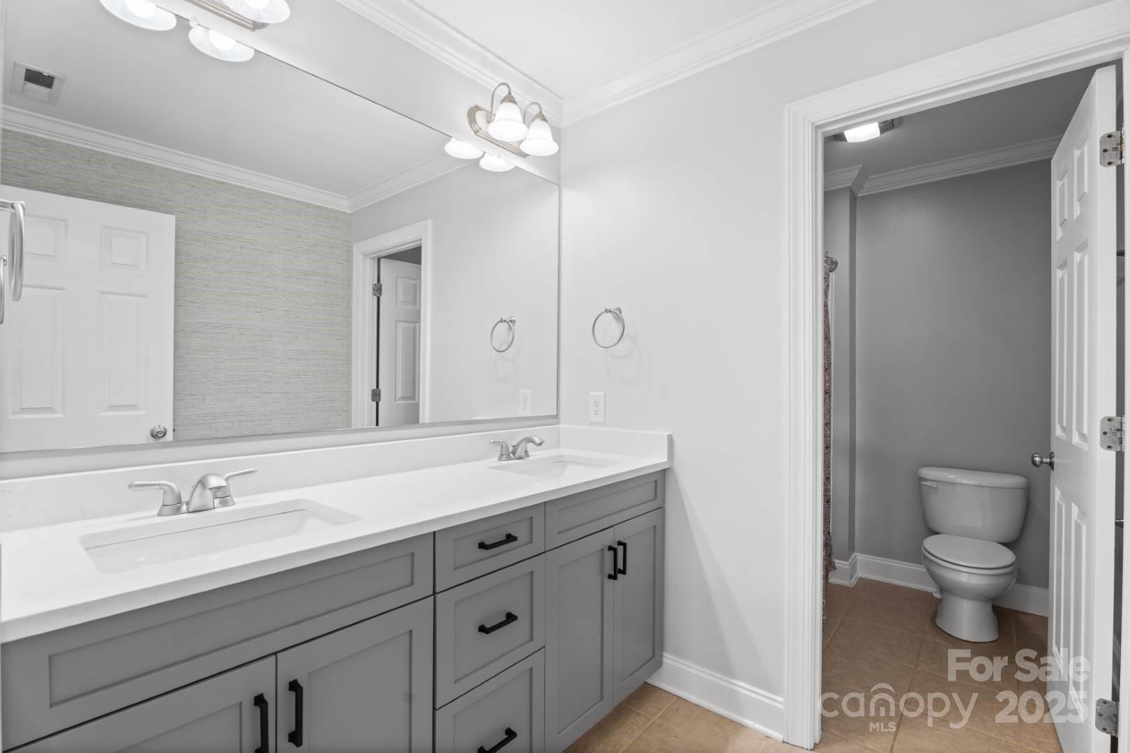 153 Canyon Road Mocksville, NC 27028 - Photo 31 of 46 a spacious bathroom with a granite countertop sink a toilet and a mirror