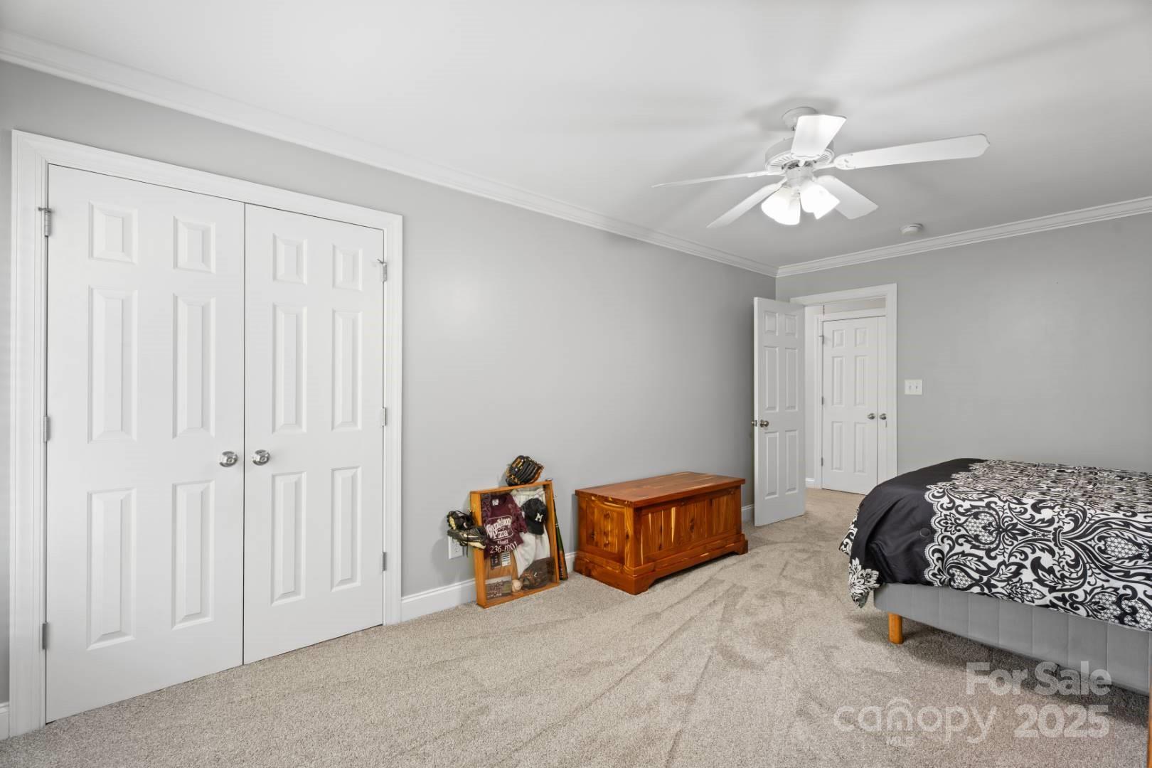 153 Canyon Road Mocksville, NC 27028 - Photo 33 of 46 a bedroom with a bed and a chandelier