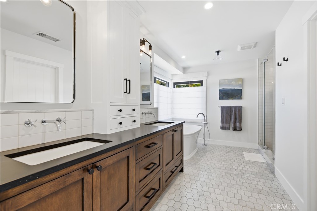 24884 Jim Bridger Road Hidden Hills, CA 91302 - Photo 17 of 31 a kitchen with granite countertop a sink and cabinets