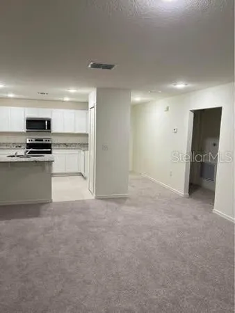 a view of a kitchen with a sink and a stove top oven