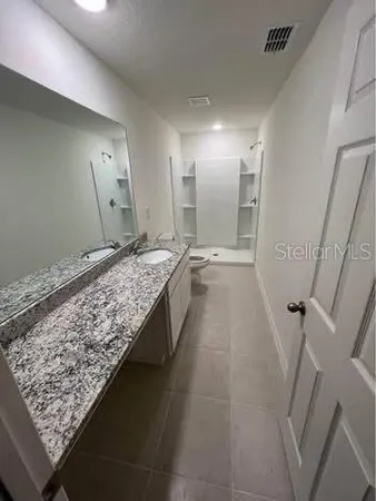 a bathroom with a sink and a large mirror