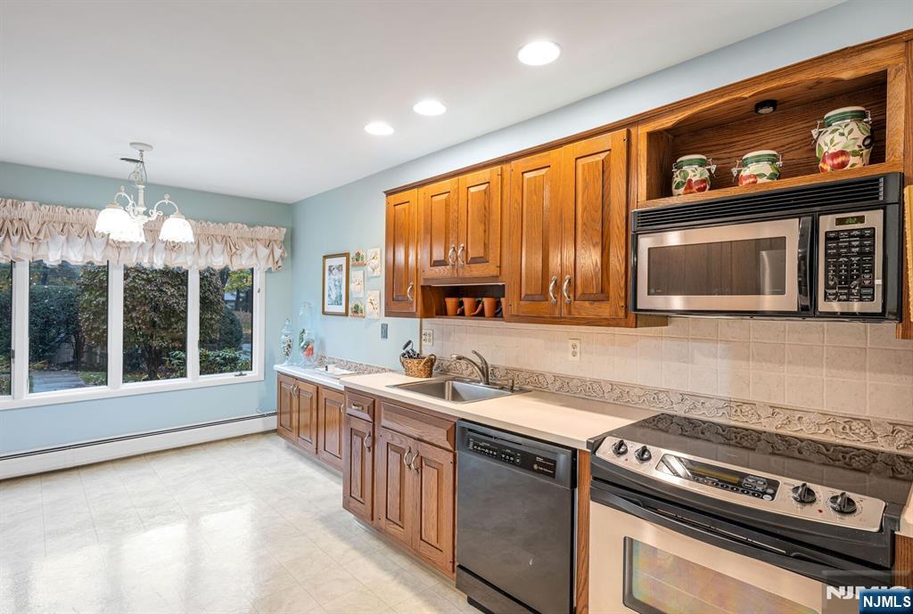444B Bromley Place Wyckoff, NJ 07481 - Photo 11 of 26 a kitchen with stainless steel appliances a stove sink and microwave