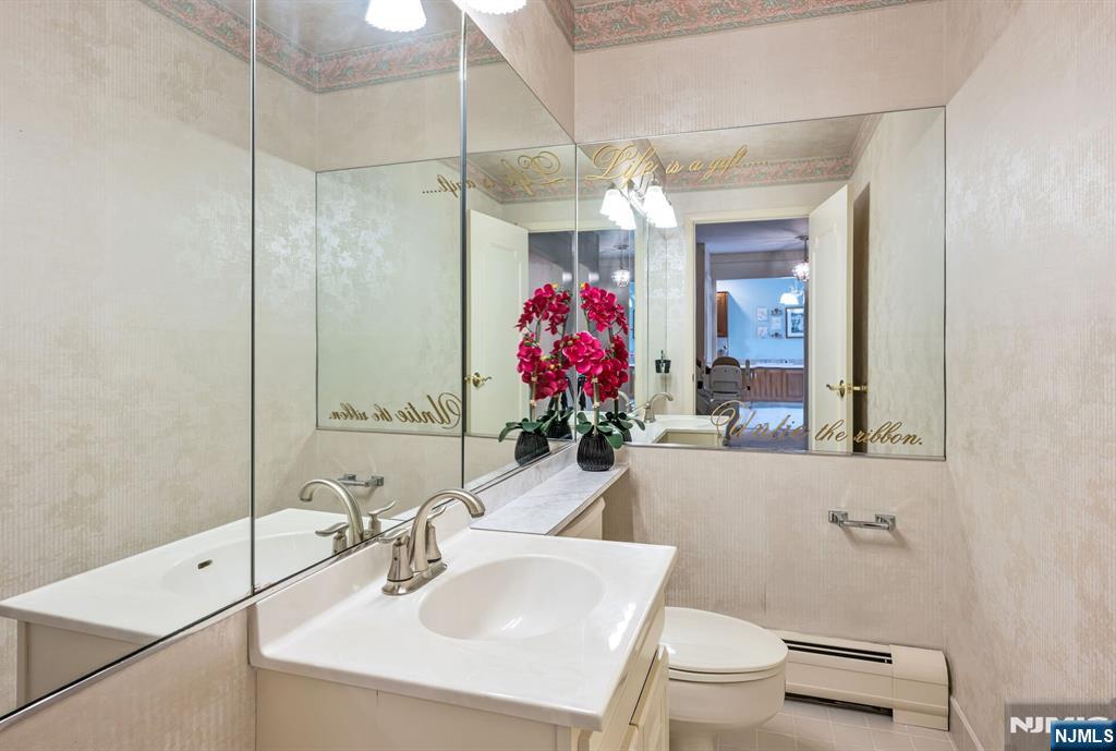 444B Bromley Place Wyckoff, NJ 07481 - Photo 14 of 26 a bathroom with a sink vanity mirror and toilet