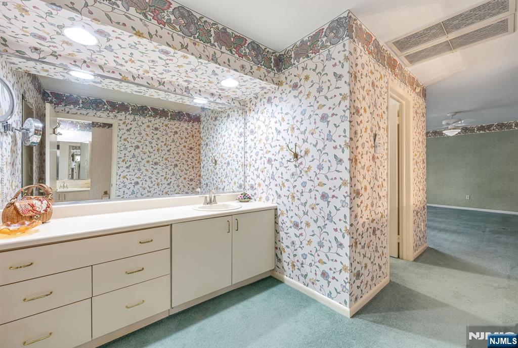 444B Bromley Place Wyckoff, NJ 07481 - Photo 18 of 26 a bathroom with a double vanity sink mirror and shower