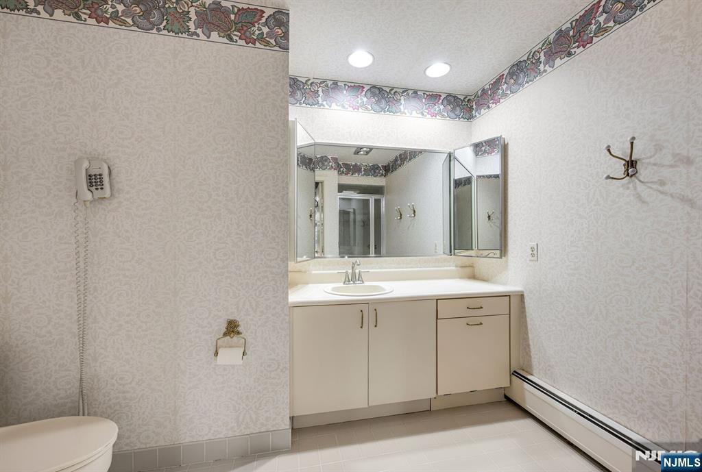 444B Bromley Place Wyckoff, NJ 07481 - Photo 19 of 26 a bathroom with a toilet sink and mirror