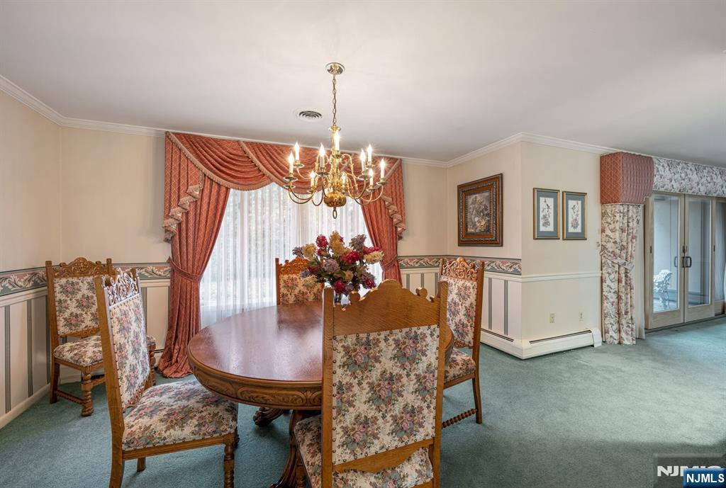 444B Bromley Place Wyckoff, NJ 07481 - Photo 7 of 26 a view of a dining room with furniture and wooden floor