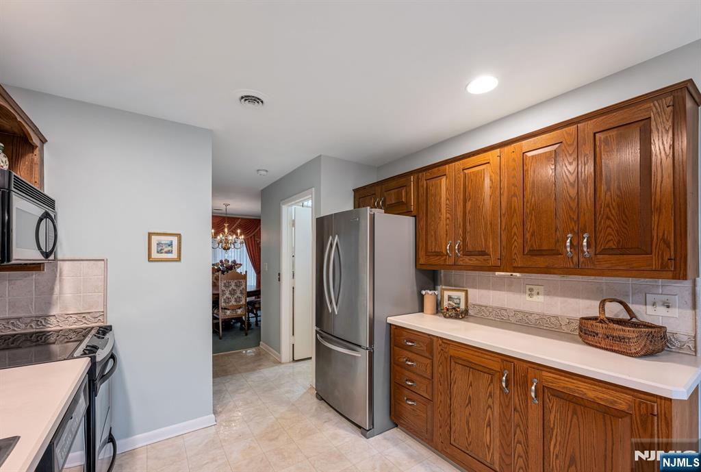 444B Bromley Place Wyckoff, NJ 07481 - Photo 10 of 26 a kitchen with stainless steel appliances granite countertop a refrigerator and a sink