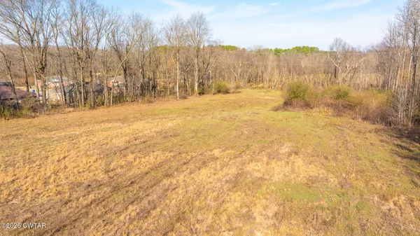 a view of large space with trees in the background