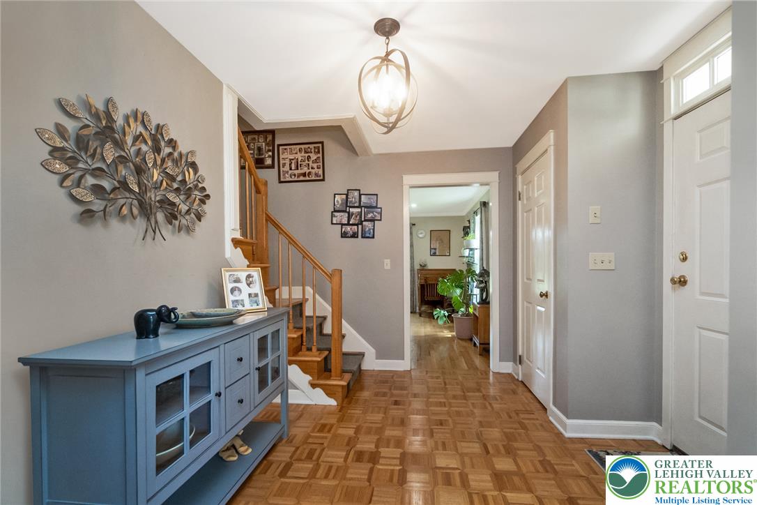 1553 Surrey Road Bethlehem, PA 18015 - Photo 5 of 92 A welcoming entryway with richly toned parquet flooring and a classic wooden staircase.