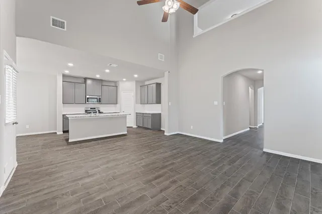 a view of a kitchen with wooden floor and a sink