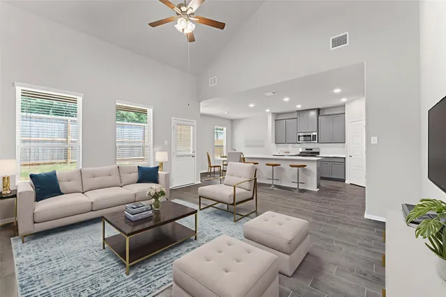 a living room with furniture and kitchen view