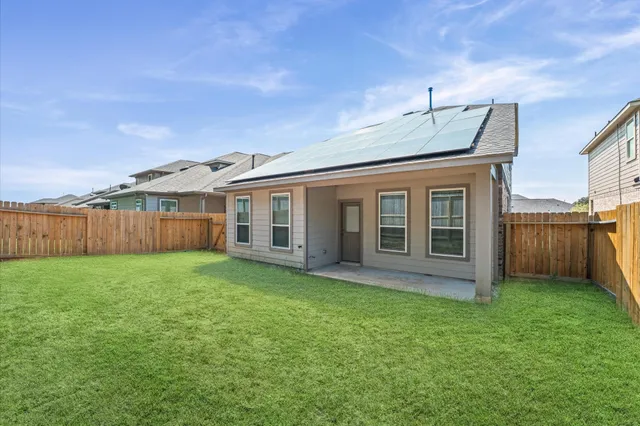 a view of a backyard with plants and large trees