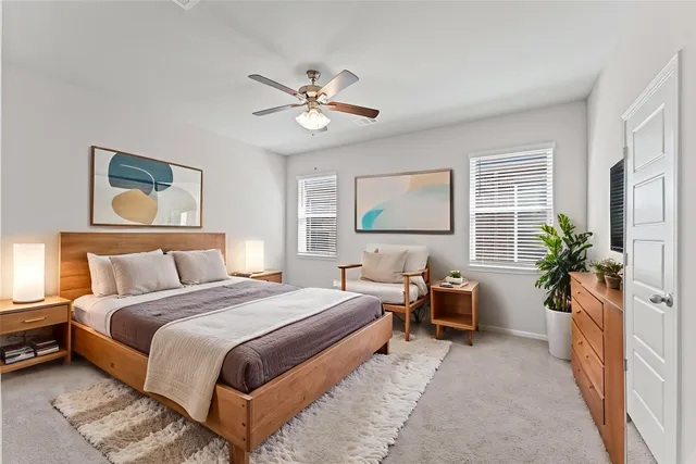 a bedroom with a large bed and a chandelier