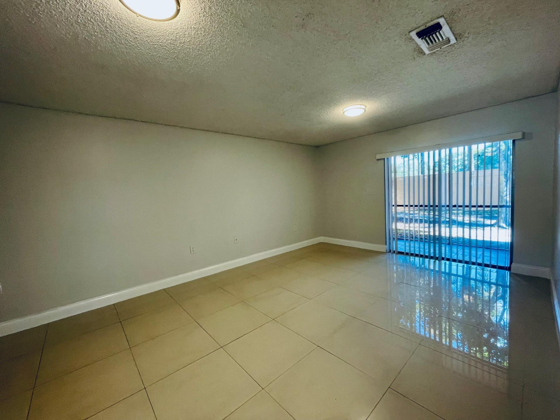 2201 Southwest 80th Terrace, Unit 2201 Miramar, FL 33025 - Photo 11 of 26 an empty room with windows