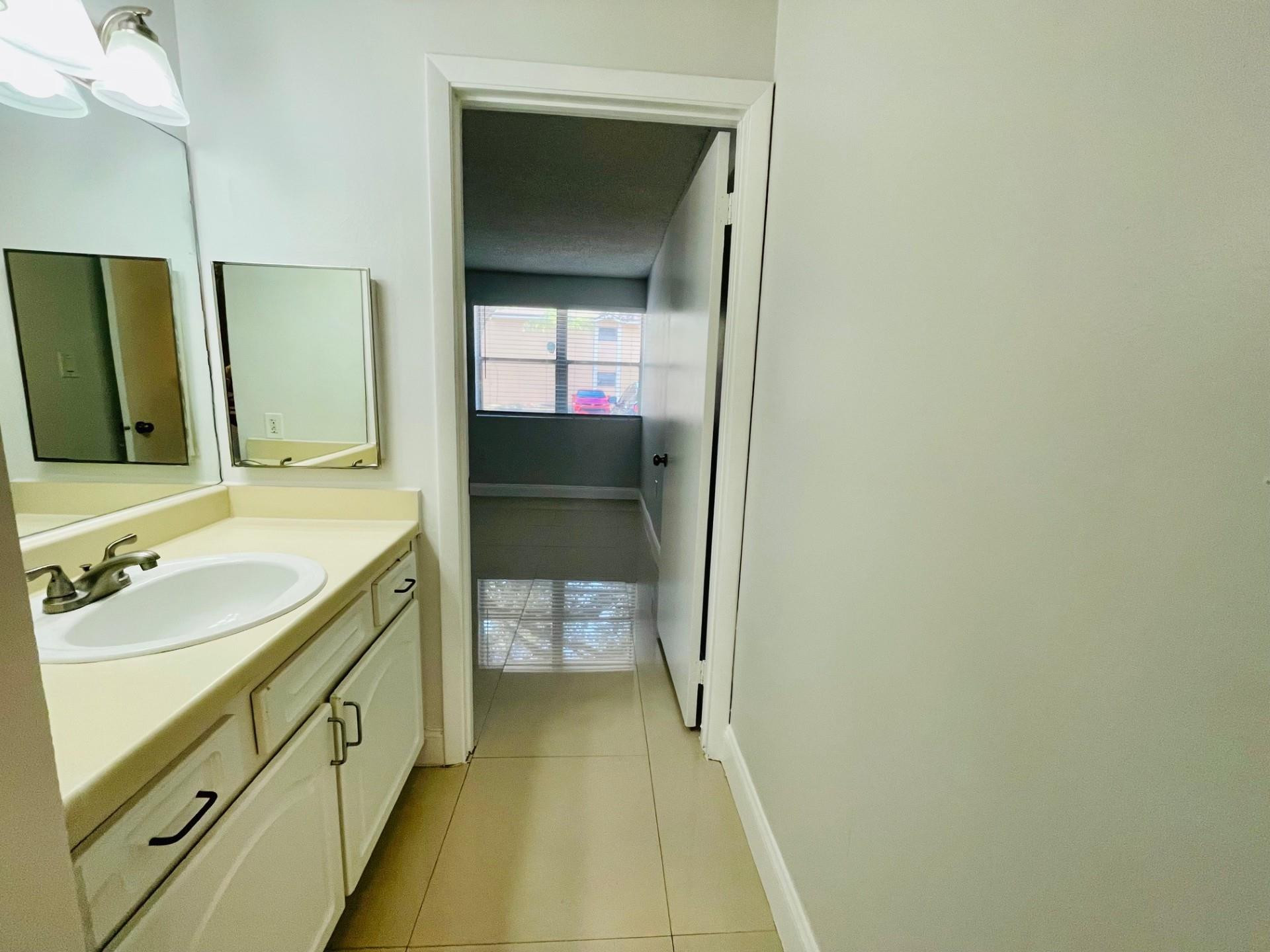 2201 Southwest 80th Terrace, Unit 2201 Miramar, FL 33025 - Photo 14 of 26 a bathroom with a sink and a mirror