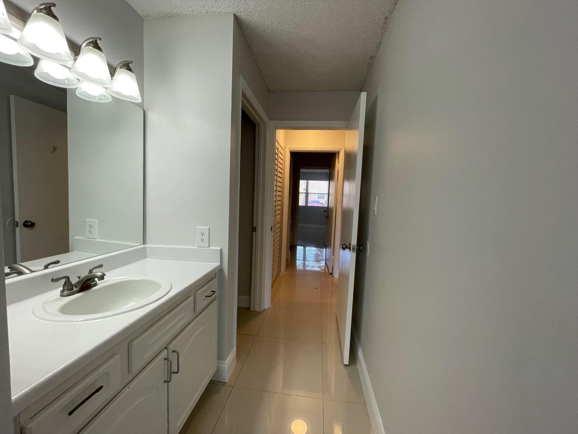 2201 Southwest 80th Terrace, Unit 2201 Miramar, FL 33025 - Photo 17 of 26 a en suite bathroom with a sink and a mirror