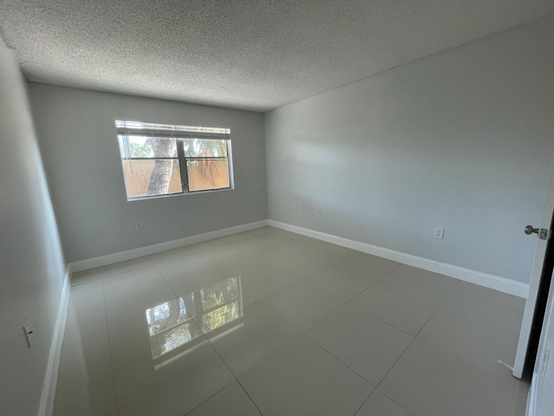2201 Southwest 80th Terrace, Unit 2201 Miramar, FL 33025 - Photo 20 of 26 an empty room with windows