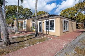 2201 Southwest 80th Terrace, Unit 2201 Miramar, FL 33025 - Photo 2 of 26 a view of a house with a large tree and wooden fence
