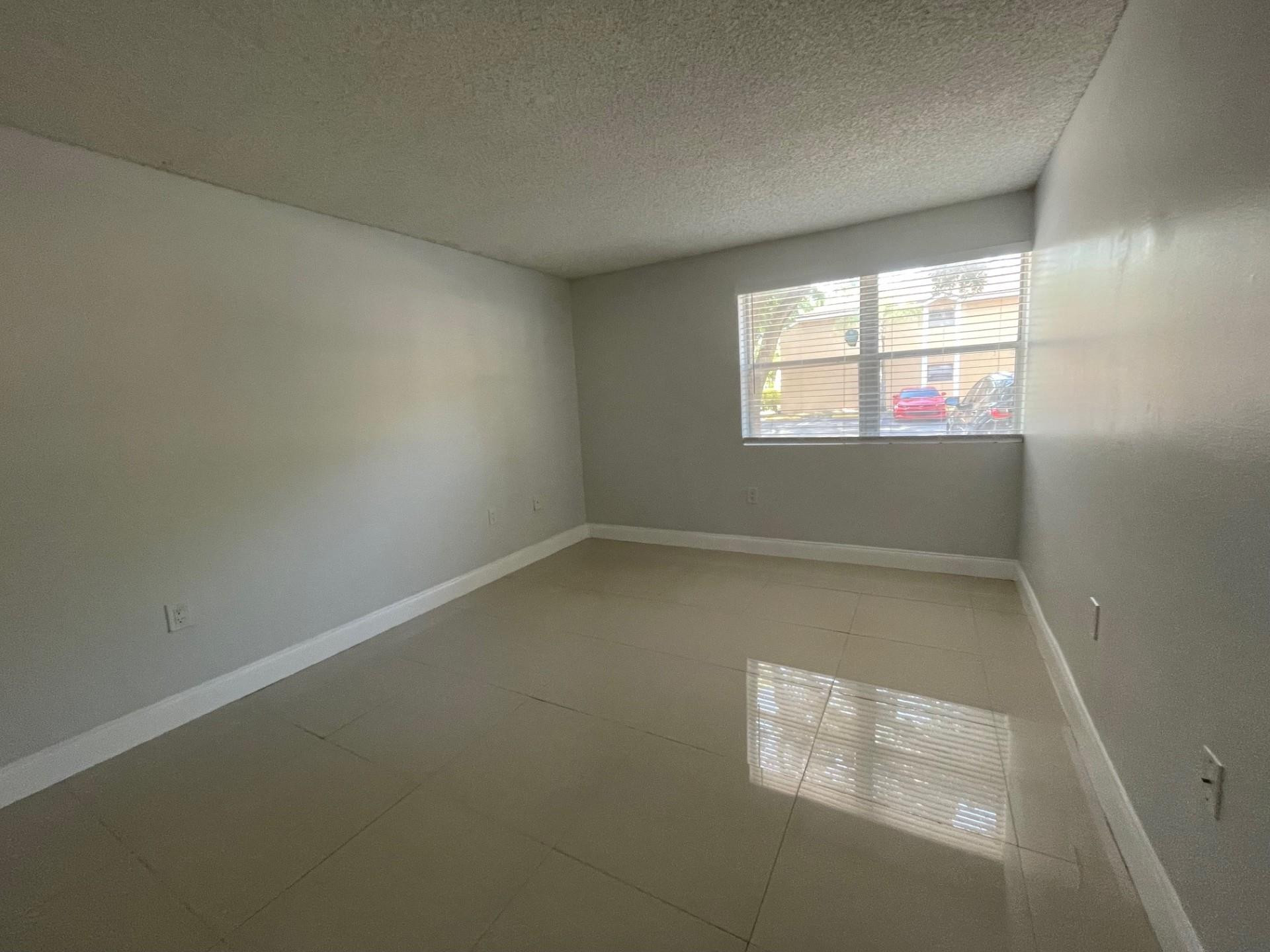 2201 Southwest 80th Terrace, Unit 2201 Miramar, FL 33025 - Photo 10 of 26 an empty room with a window