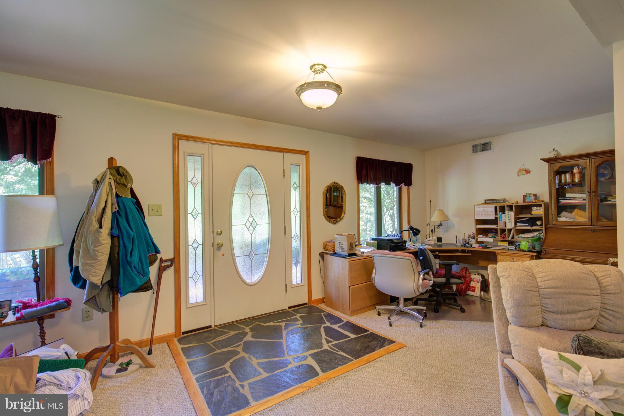 2619 Apple Pie Ridge Road Winchester, VA 22603 - Photo 24 of 29 a living room with furniture a rug and gym equipment