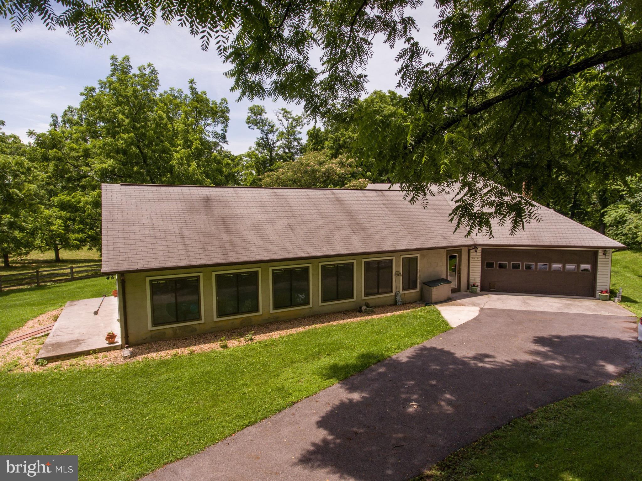 2619 Apple Pie Ridge Road Winchester, VA 22603 - Photo 4 of 29 a front view of a house with a garden and yard