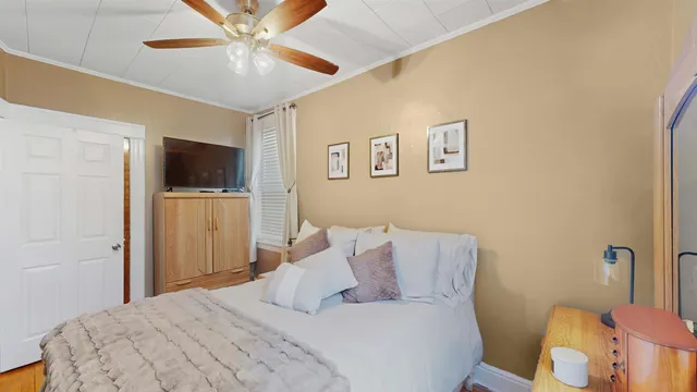 a bedroom with a bed and a flat screen tv