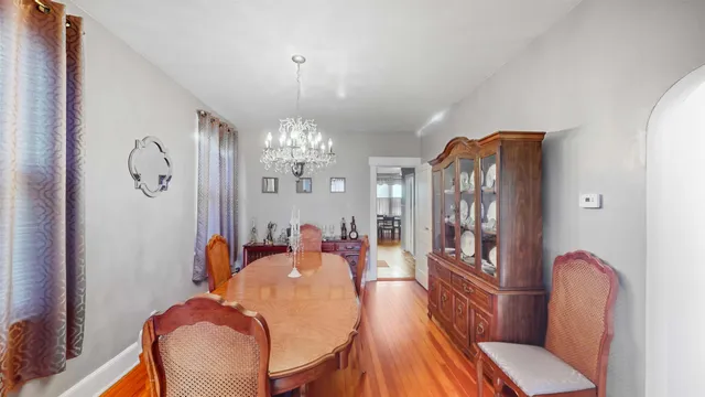 a view of a dining room with furniture and chandelier