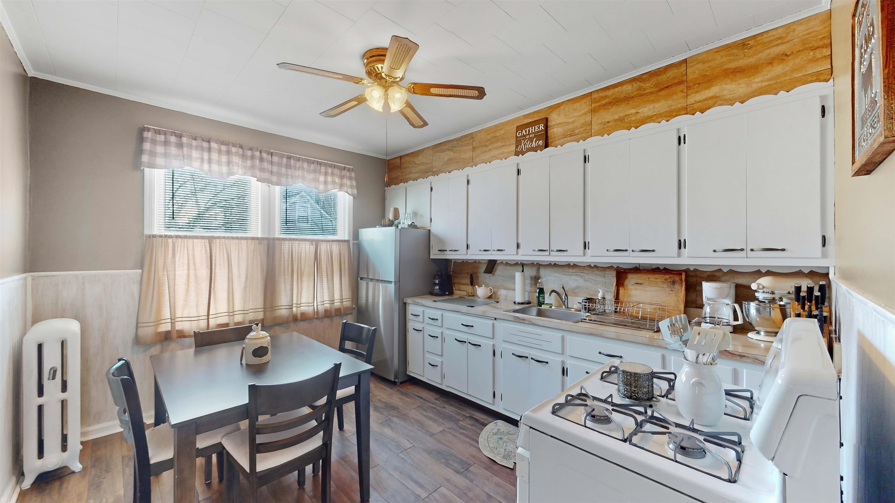 159 West 32nd Street Bayonne, NJ 07002 - Photo 22 of 47 a kitchen with stainless steel appliances granite countertop a stove a refrigerator a sink dishwasher a dining table and chairs with wooden floor
